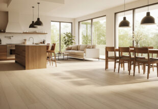 Open-concept kitchen and living room with natural light, showcasing a modern and spacious light wood-colored vinyl plank (LVP) floor. The image highlights the aesthetic value and interior design.