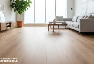 Installation of wide clear vinyl flooring in a modern living room with large windows, brand American Flooring Professionals.